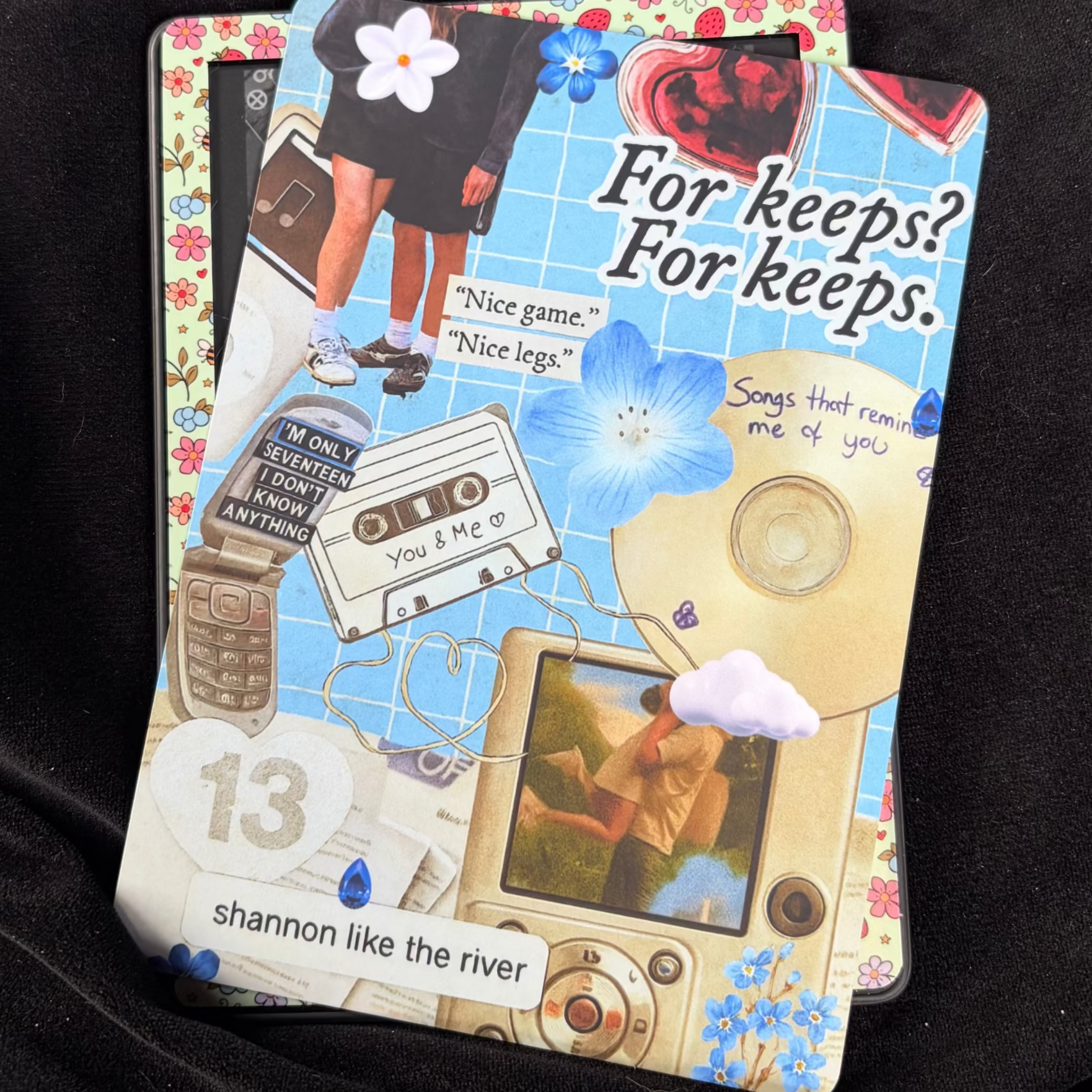 Binding 13-inspired Kindle backing insert with a blue scrapbook collage, number 13, cassette tape, flip phone, flowers and For keeps quote
