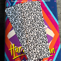 Black and white spooky cheetah print bookmark with hidden slasher-mask faces throughout the pattern
