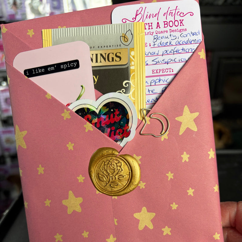 Blind date with a book, mystery book, fantasy genre, pink wrapping and gold seal/ handmade bookmark and sticker. bookish merch. gold stars. reader core. gift for reader