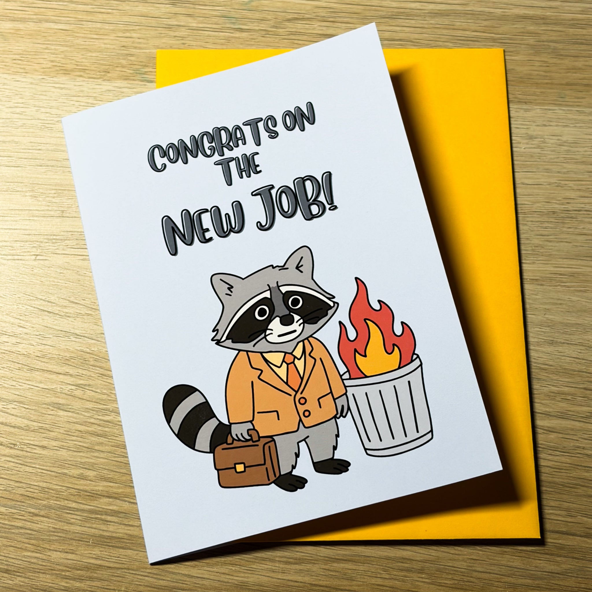 Congrats On The New Job, Greeting Card. Raccoon, feral, funny, meme, raccoon wearing a suit with a briefcase next to a dumpster fire