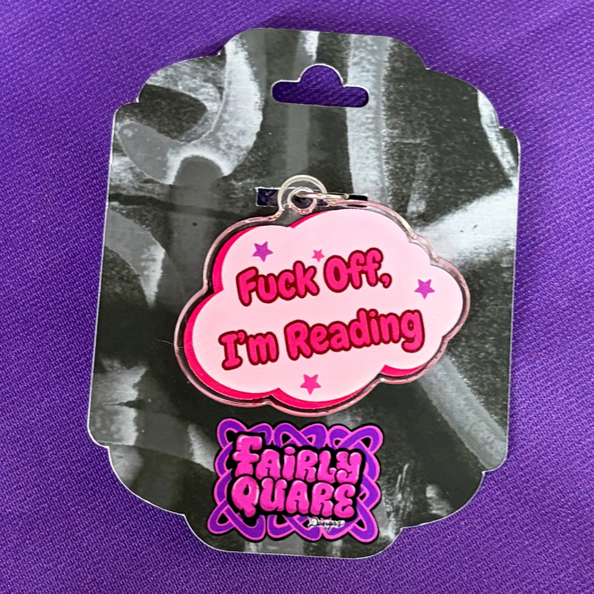 Pink speech-bubble USB-C Kindle and phone charm reading Fuck Off I’m Reading in dark pink lettering with purple and pink stars
