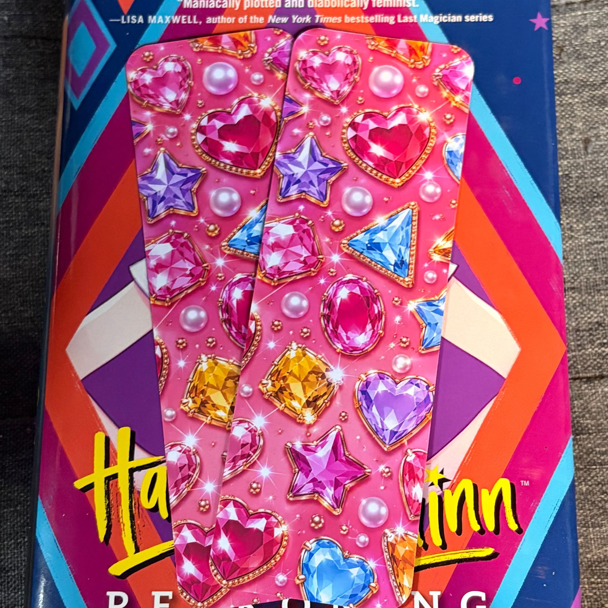 Hot pink Y2K bookmark printed with colourful heart, star and diamond-shaped gemstones, pearls and gold details
