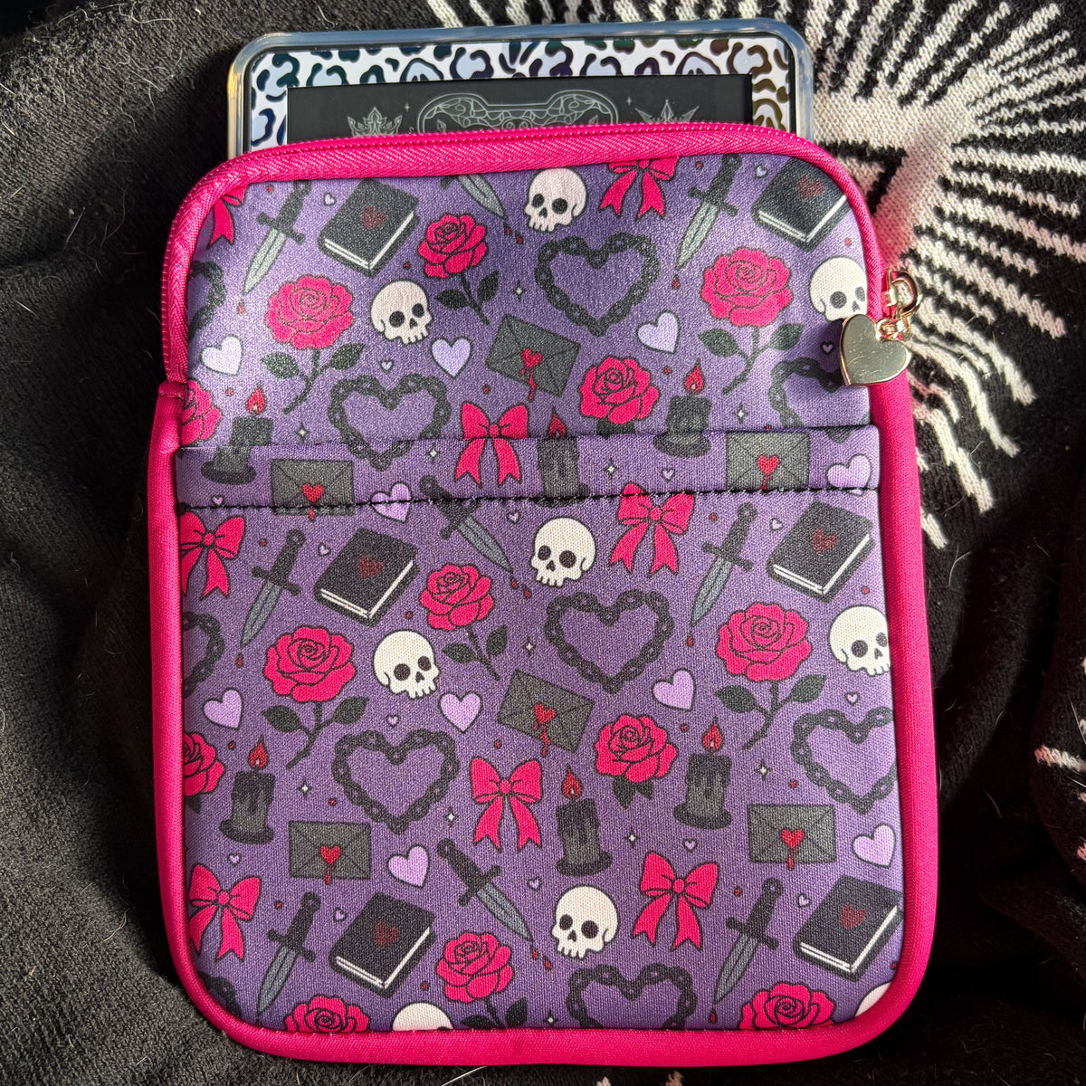 Purple neoprene Kindle pouch with pink roses, bows, skulls and swords, hot pink trim, front pocket and gold zip hardware