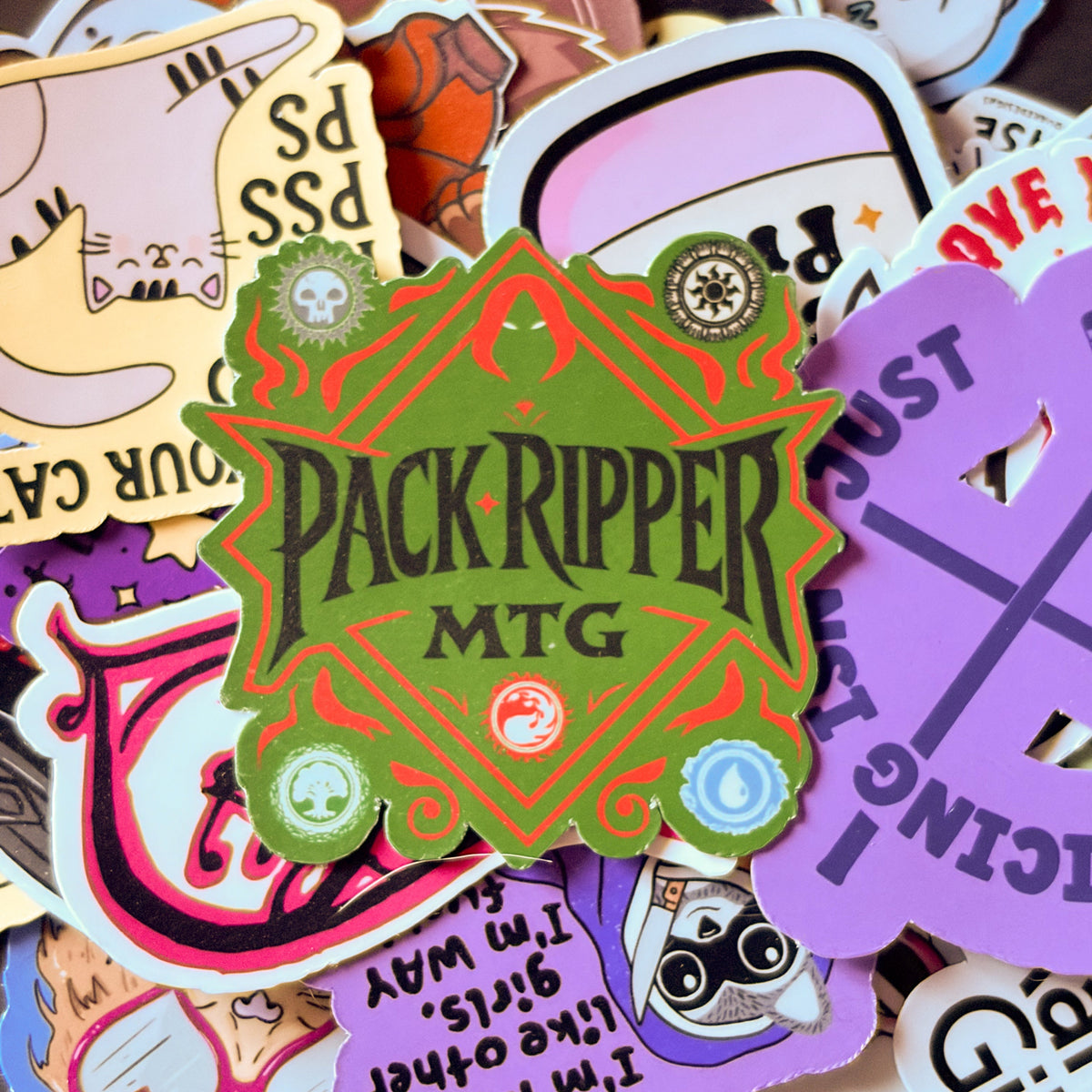 Green and red Pack Ripper MTG sticker featuring black gothic lettering surrounded by five Magic: The Gathering mana symbols
