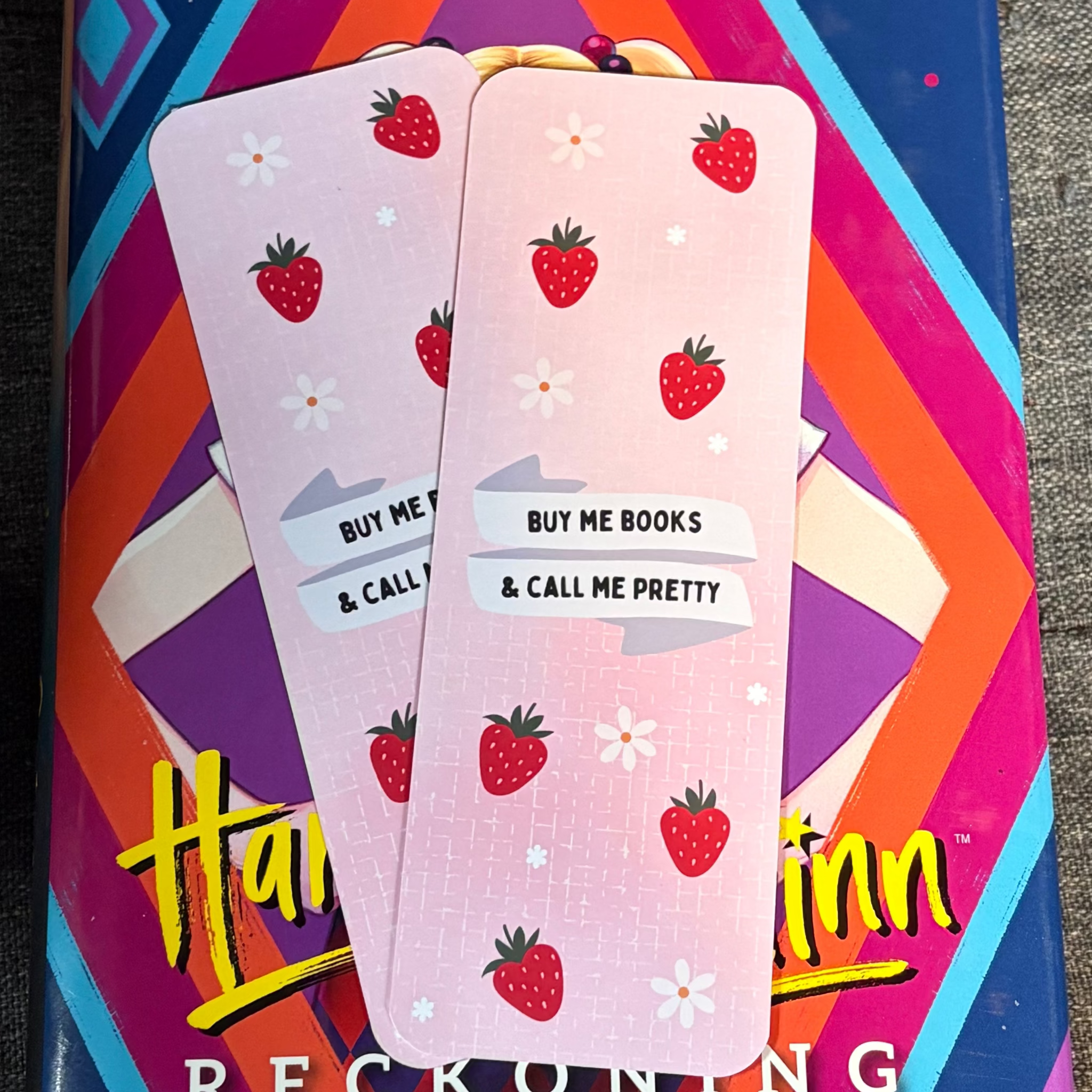 Pale pink strawberry bookmark with daisies and Buy Me Books and Call Me Pretty lettering
