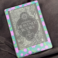 Pink Daisy Meadow removable front Kindle skin with pink flowers and green leaves on a turquoise background
