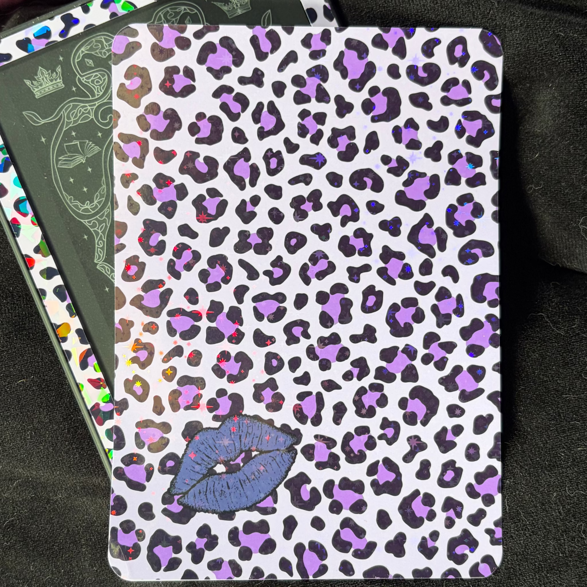 White Kindle backing insert with black and purple leopard print, blue-purple lips and a multicoloured glitter finish
