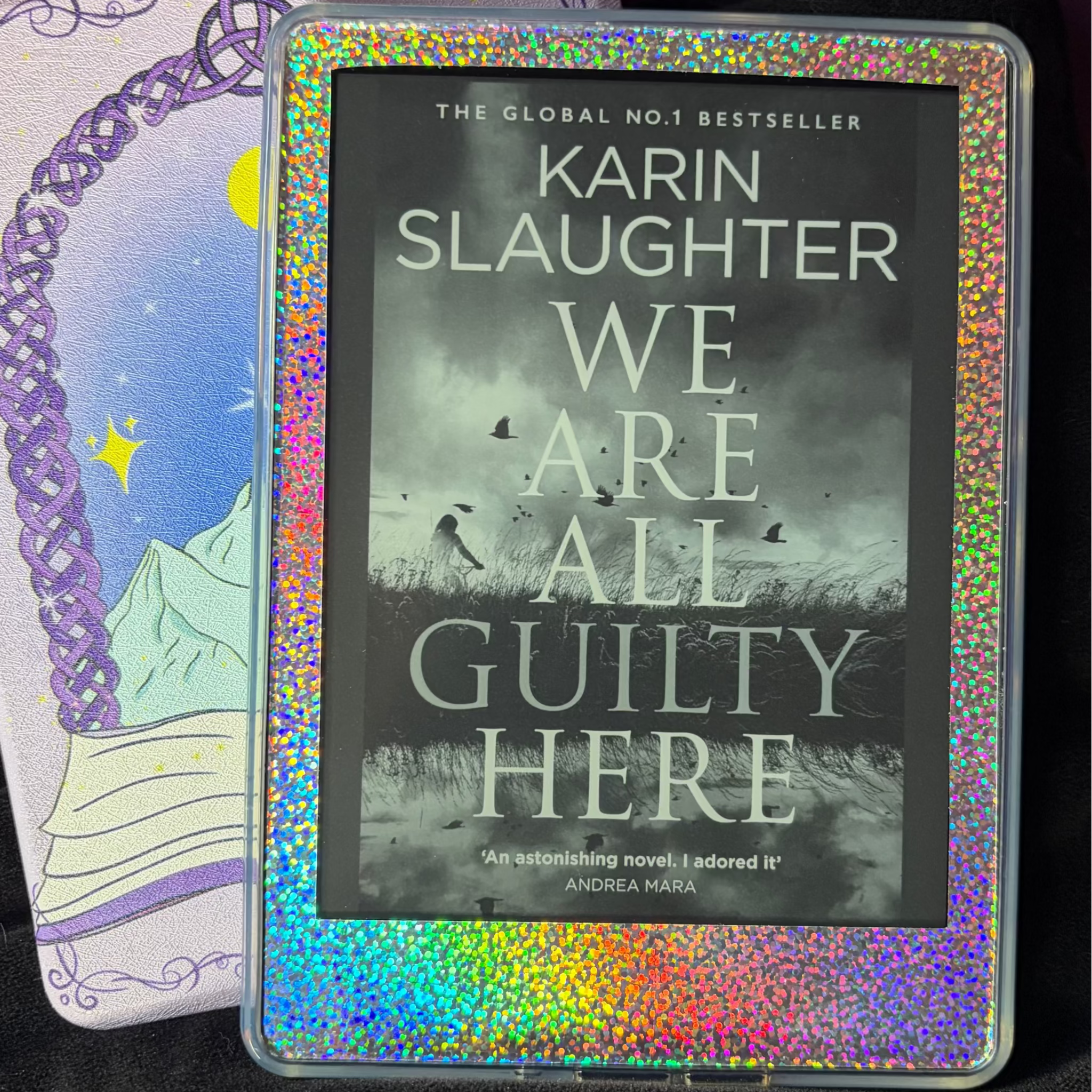 Rainbow holographic vinyl skin applied to the front border surrounding a Kindle screen
