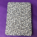 Black and cream Spooky Cheetah Kindle case featuring cheetah spots with hidden Ghostface-style masks
