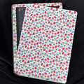 Strawberry Meadow Kindle backing insert with pink flowers, strawberries, blueberries and little bees on a pale mint background
