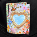 Through the looking glass, Summer Edition, Kindle backing insert. Butterfly. blue sky. gold mirror. Floral garden. Bright.

Made to order. Made to fit your specific model. Matte laminated for durability. Easy to install in a clear case.