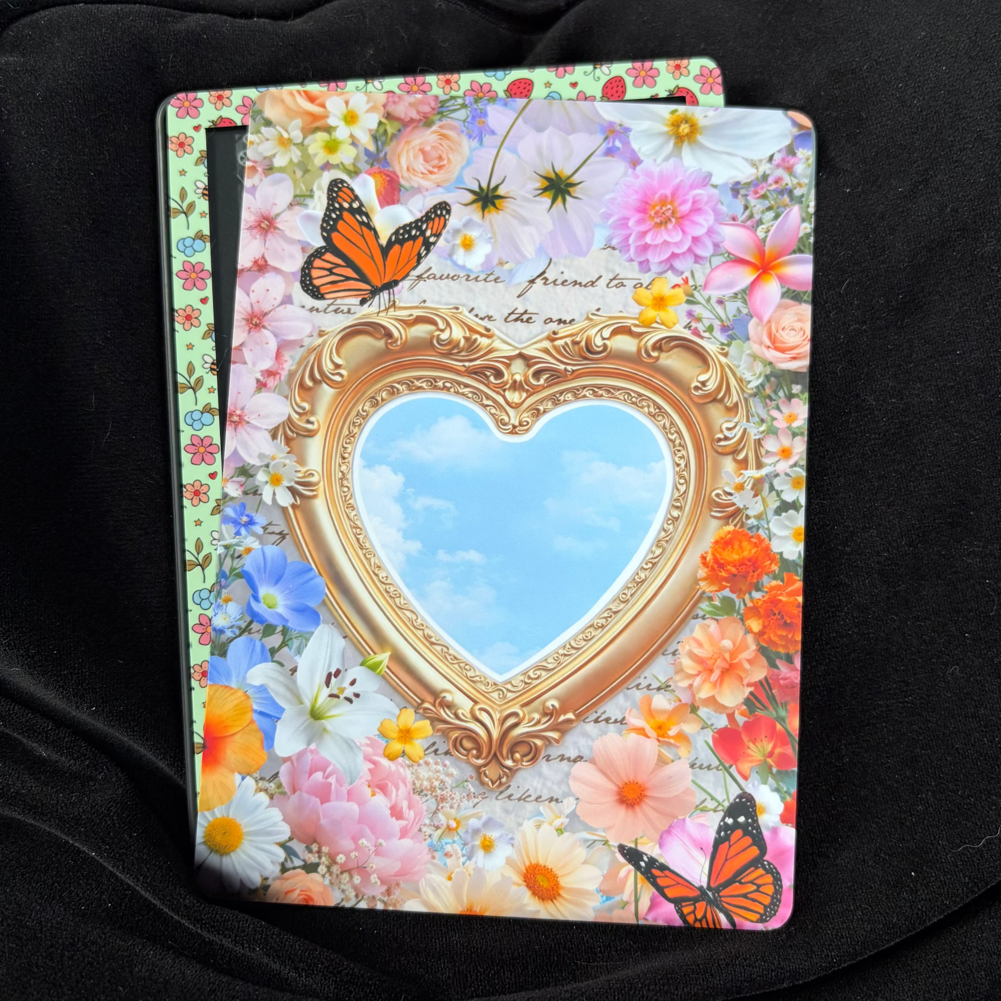 Through the looking glass, Summer Edition, Kindle backing insert. Butterfly. blue sky. gold mirror. Floral garden. Bright.

Made to order. Made to fit your specific model. Matte laminated for durability. Easy to install in a clear case.