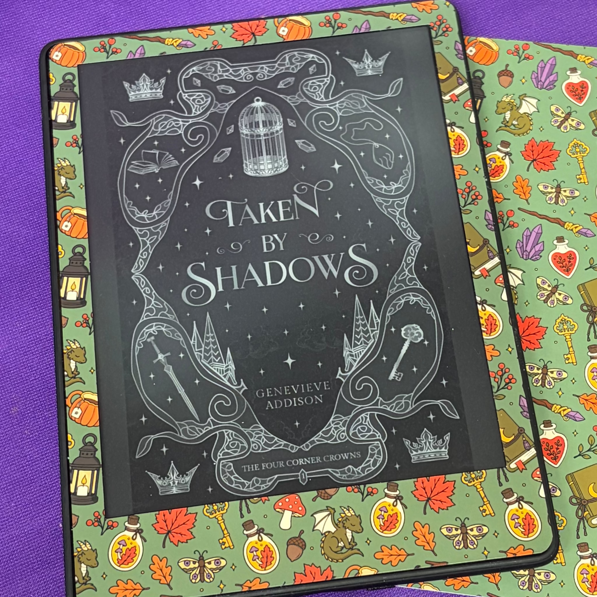 Green Witchy Woodland Autumn Kindle front skin patterned with foxes, books, lanterns, potion bottles, mushrooms, keys and autumn leaves
