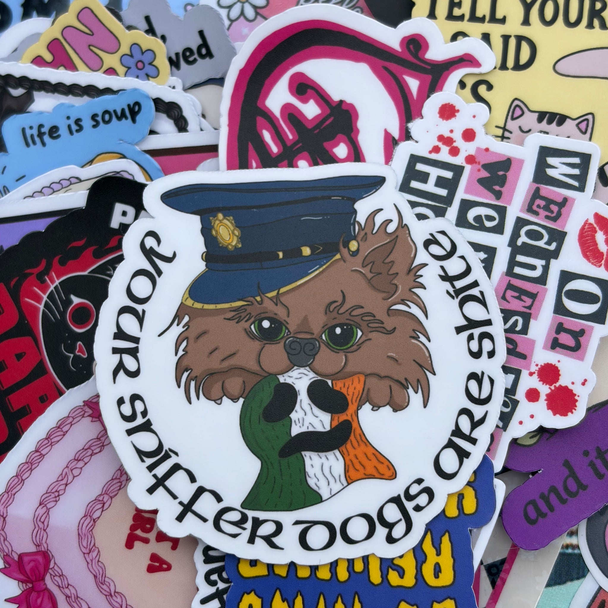 Your sniffer dogs are shite. &nbsp;Single Sticker. Kneecap inspired, cute dog, Irish culture meme, funny police hat police dog pomeranian